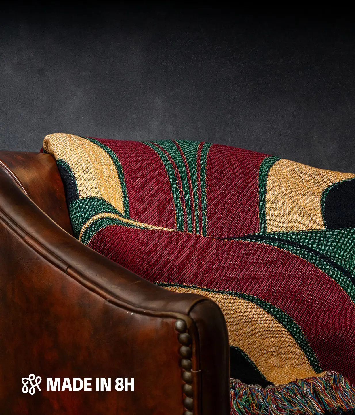 Product image draped over a leather chair in a moody environment