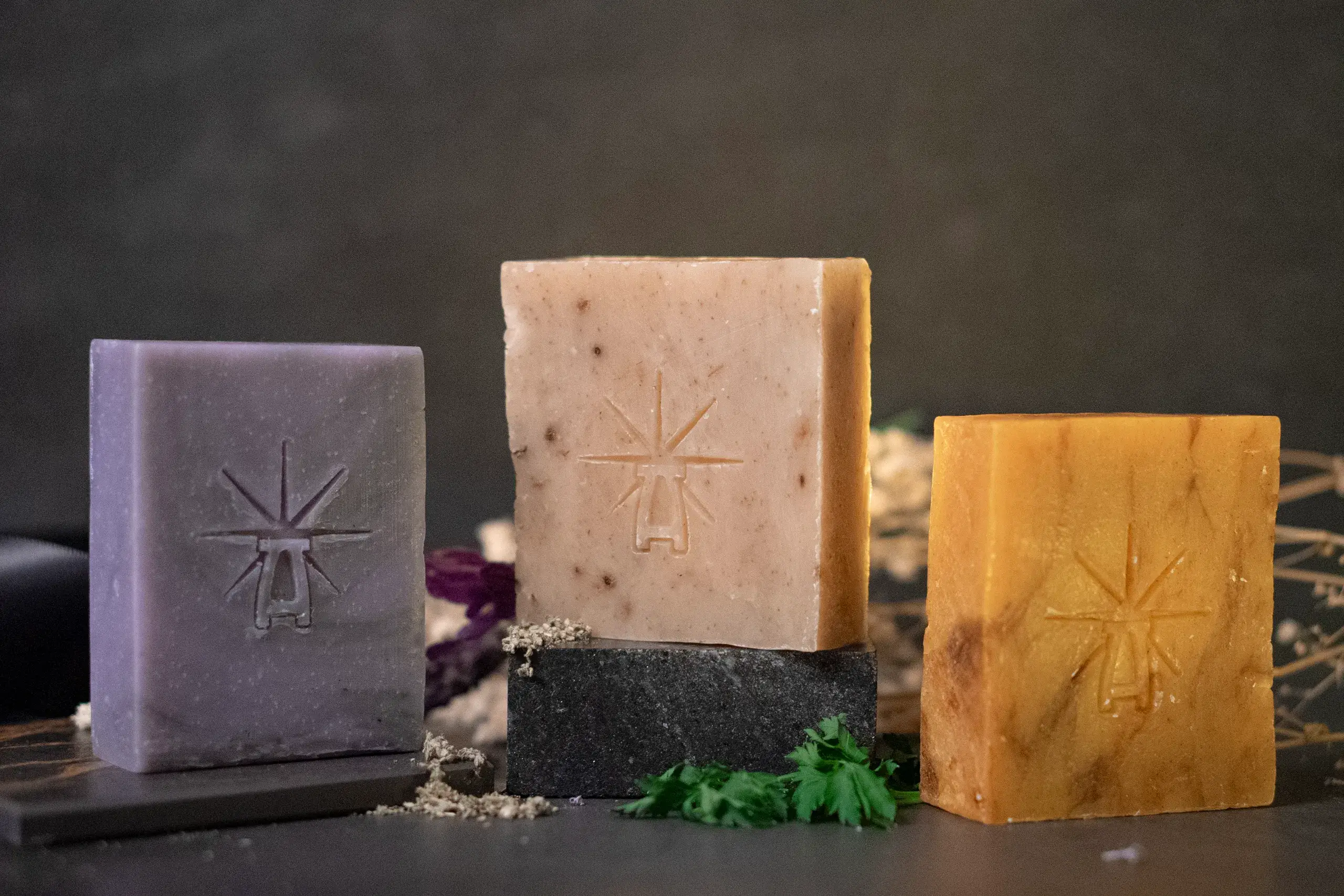 3 Bars of soap sit on altars surrounded by ingredients